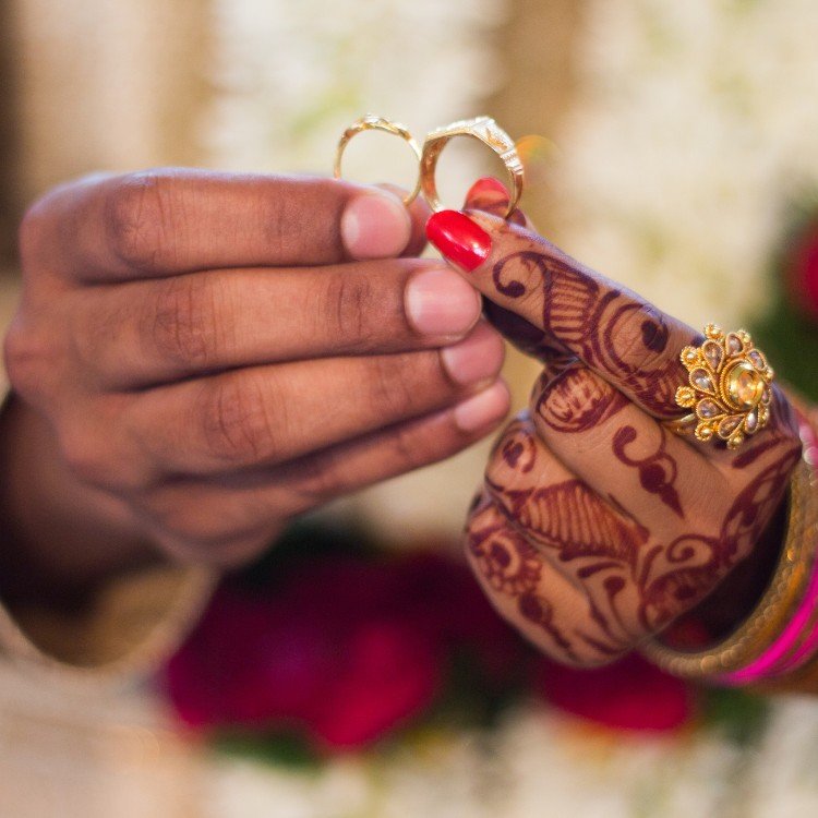 bride and groom showing gold wedding ring bride and groom showing gold wedding ring